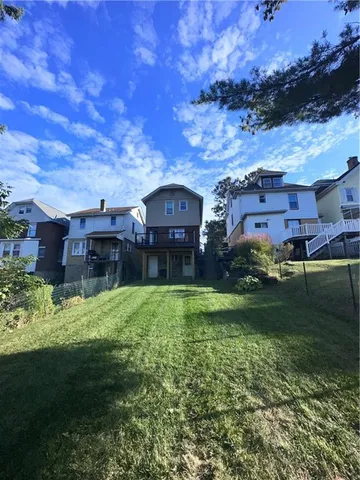 a aerial view of a house next to a yard