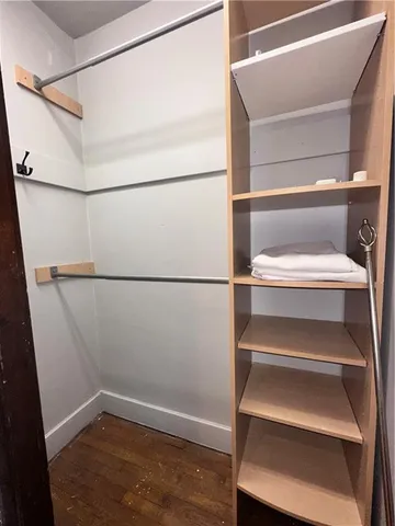 a view of walk in closet with empty racks