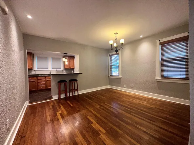 a view of a livingroom with furniture wooden floor and a window