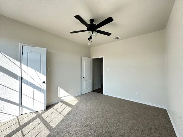 a view of room with window and ceiling fan