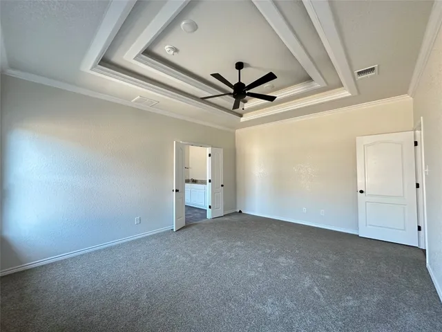 en empty room with a ceiling fan and window