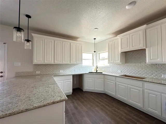 a kitchen with sink and cabinets
