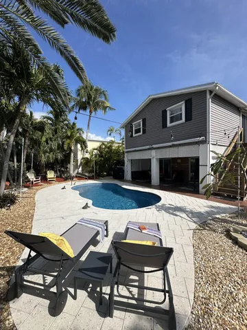 a view of a backyard with sitting area