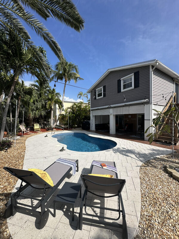a view of a backyard with sitting area