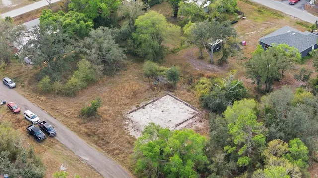 an aerial view of a house with a yard