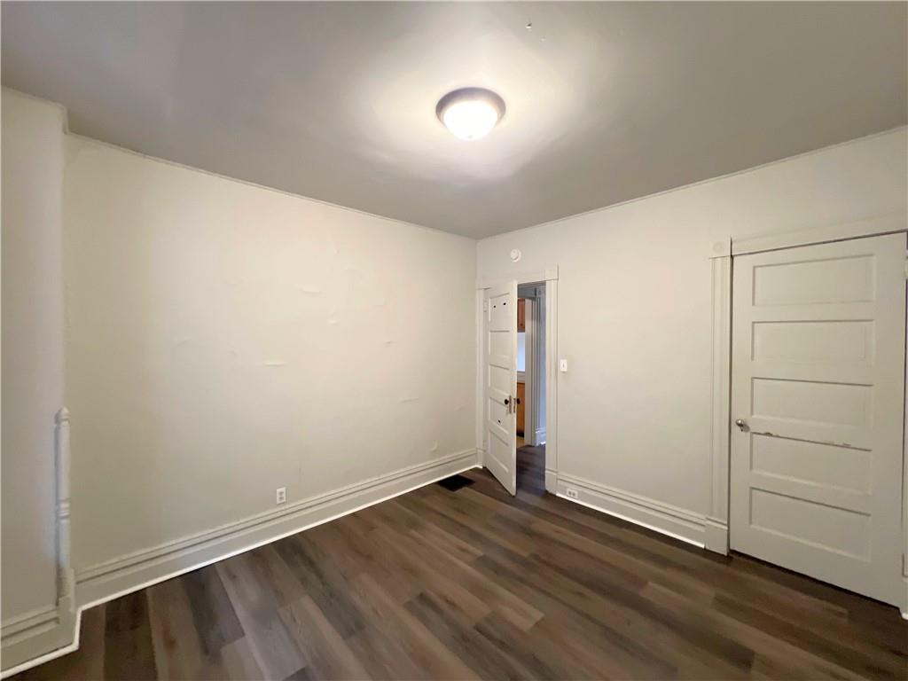 518 Middle Avenue, Unit B Wilmerding, PA 15148 - Photo 5 of 5 an empty room with wooden floor and windows