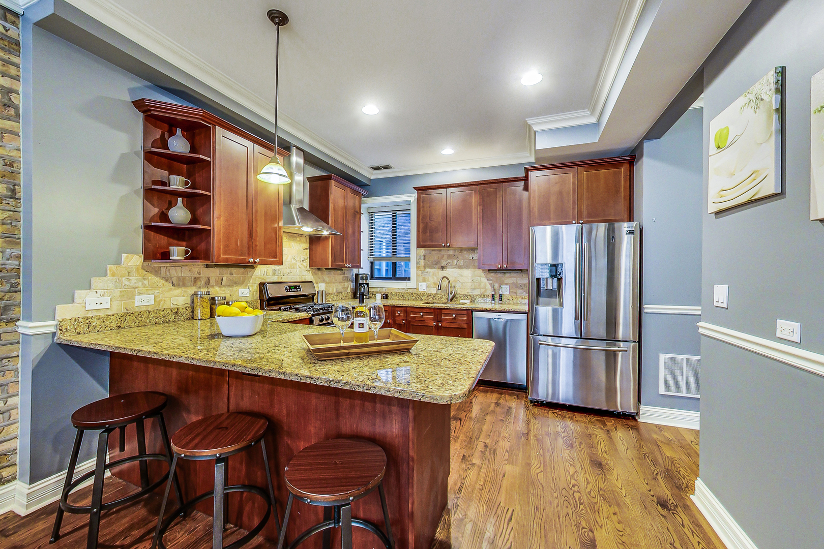 5219 North Winthrop Avenue, Unit 2N Chicago, IL 60640 - Photo 14 of 32 a kitchen with refrigerator a sink and chairs