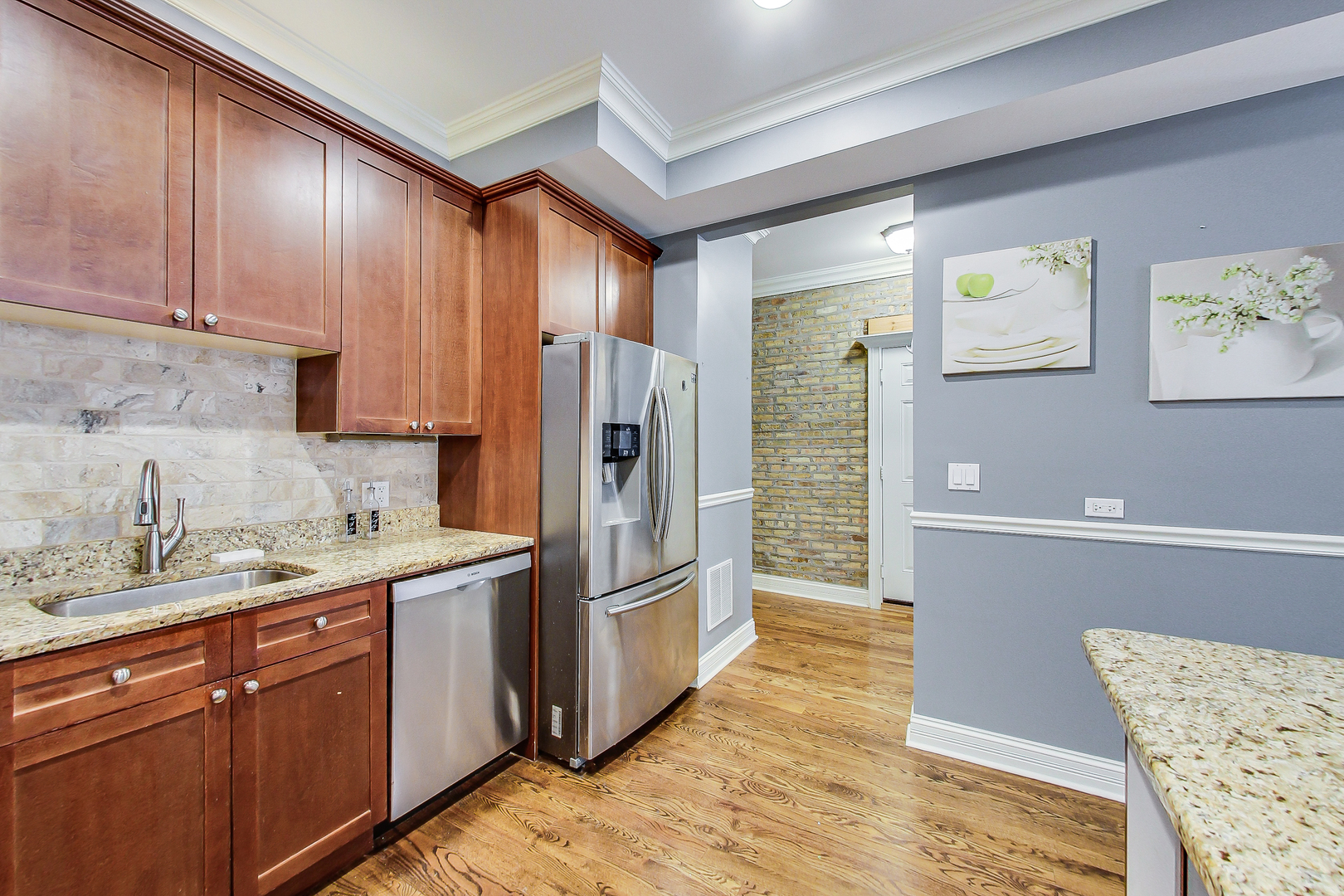 5219 North Winthrop Avenue, Unit 2N Chicago, IL 60640 - Photo 16 of 32 a kitchen with stainless steel appliances granite countertop a refrigerator and a sink