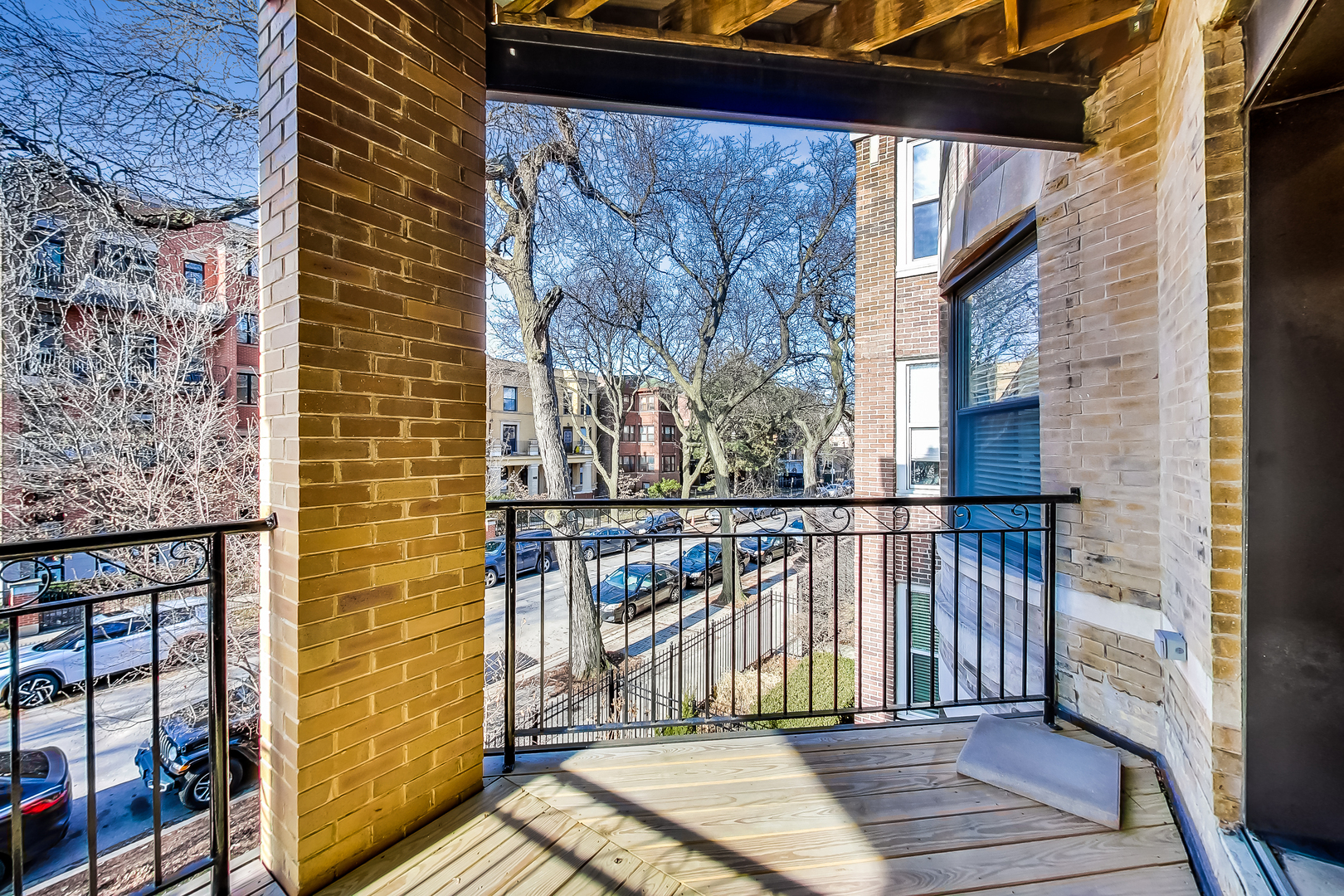 5219 North Winthrop Avenue, Unit 2N Chicago, IL 60640 - Photo 29 of 32 a view of a balcony with wooden floor and fence