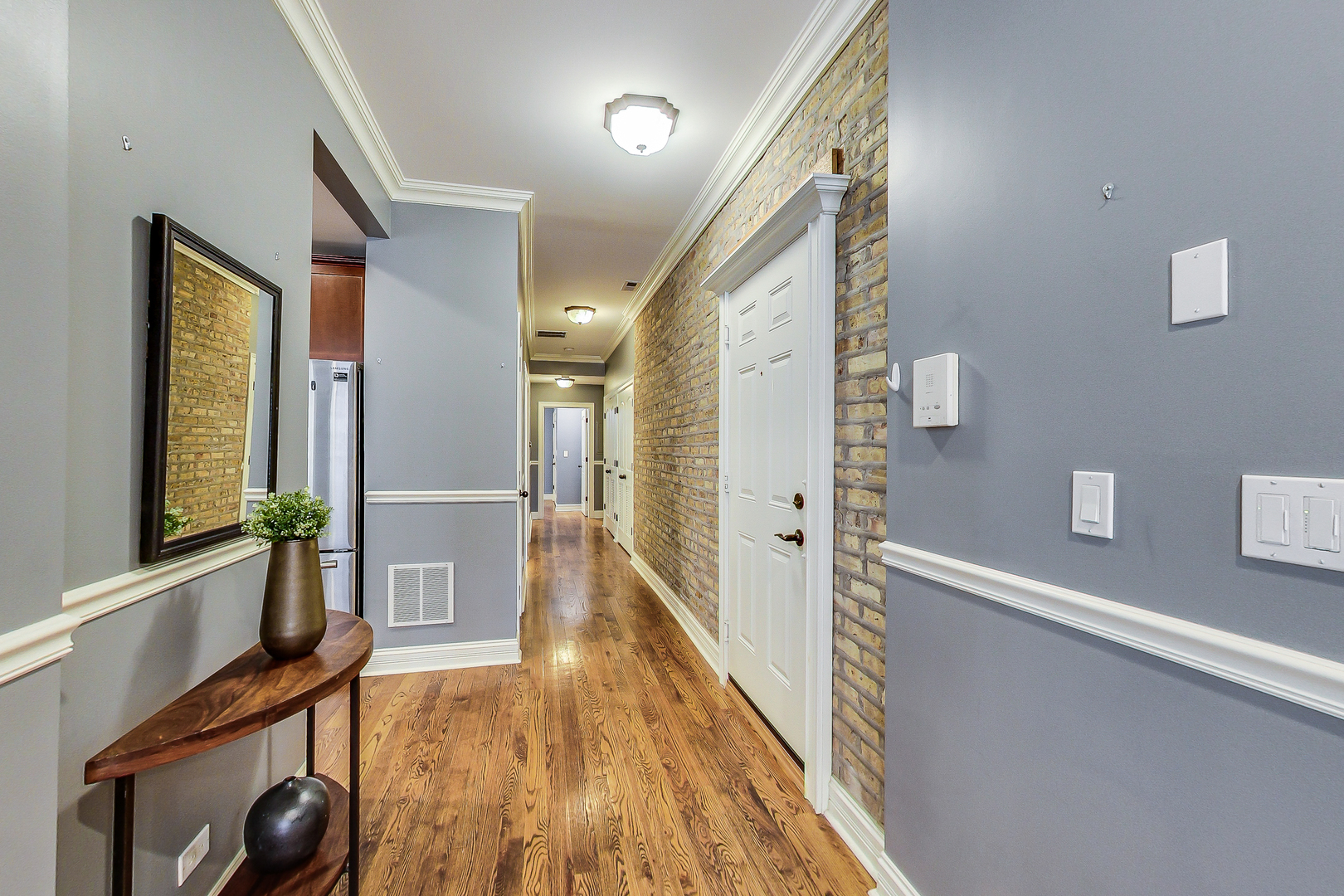 5219 North Winthrop Avenue, Unit 2N Chicago, IL 60640 - Photo 7 of 32 a view of a hallway with wooden floor and staircase