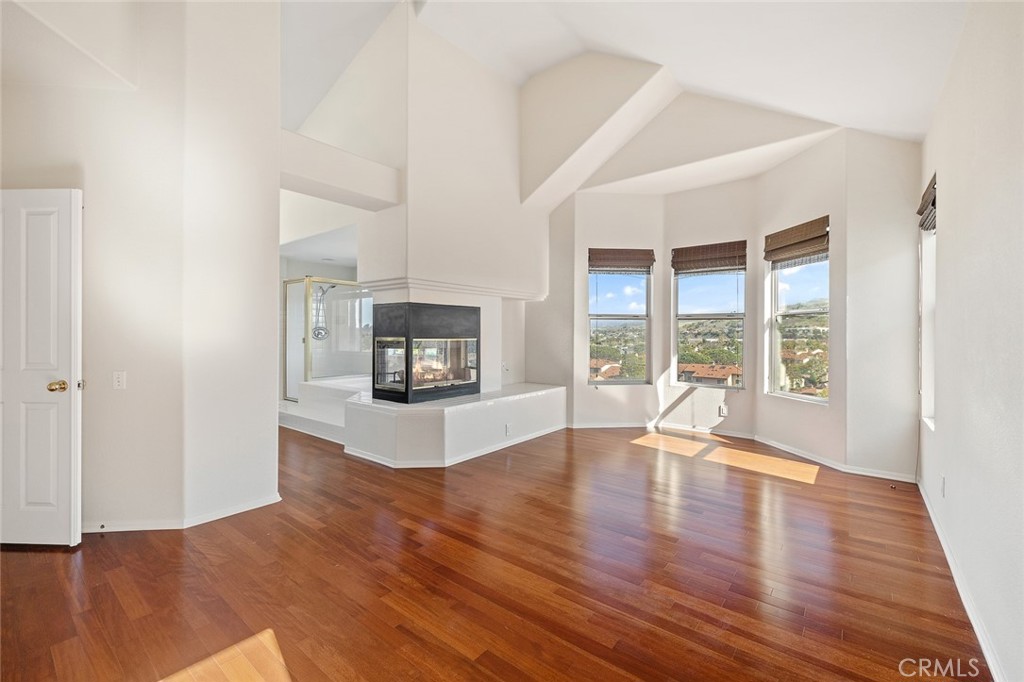 33686 Bridgehampton Drive Dana Point, CA 92629 - Photo 21 of 29 a view of empty room with wooden floor and fireplace