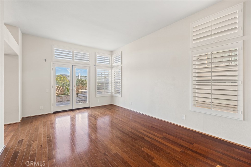 33686 Bridgehampton Drive Dana Point, CA 92629 - Photo 5 of 29 a view of an empty room with wooden floor and a window