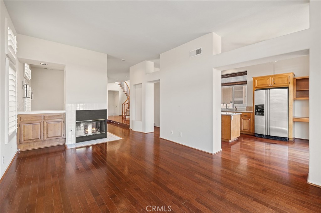 33686 Bridgehampton Drive Dana Point, CA 92629 - Photo 6 of 29 a view of a living room a kitchen with wooden floor and electronic appliances