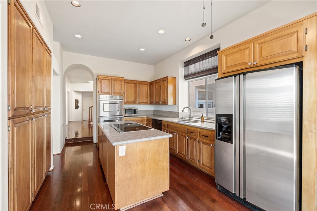 33686 Bridgehampton Drive Dana Point, CA 92629 - Photo 8 of 29 a kitchen with stainless steel appliances granite countertop a refrigerator a sink and a stove