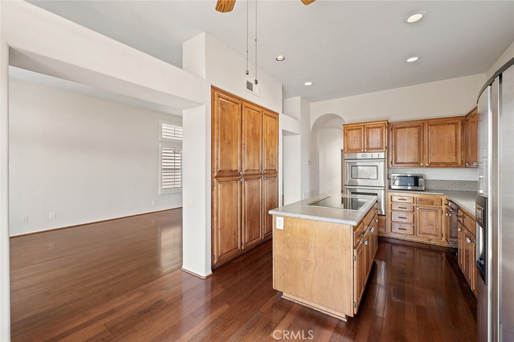 33686 Bridgehampton Drive Dana Point, CA 92629 - Photo 9 of 29 a room with stainless steel appliances granite countertop a refrigerator a sink dishwasher a stove and white countertops with wooden floor