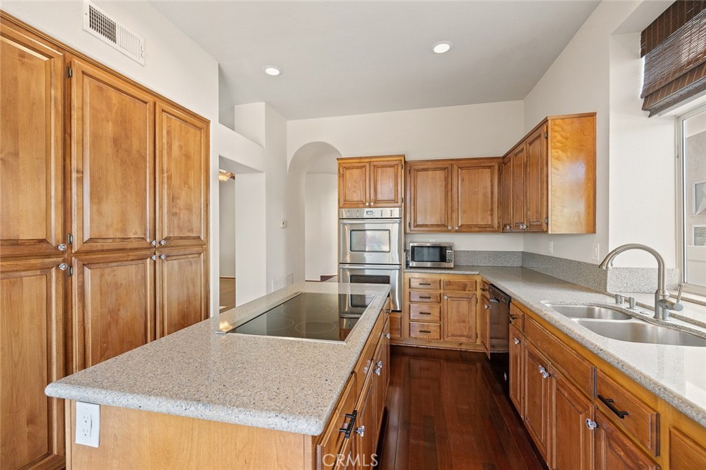 33686 Bridgehampton Drive Dana Point, CA 92629 - Photo 10 of 29 a kitchen with granite countertop a sink a counter space appliances and cabinets