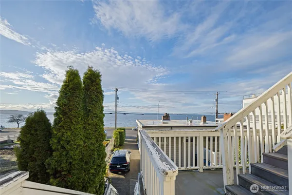 a view of a chair and tables in the balcony