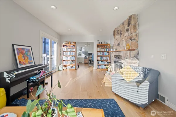 a living room with furniture and a wooden floor