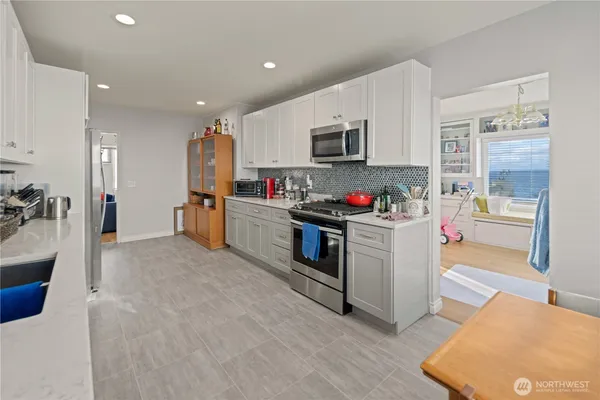 a view of a livingroom with workspace and a couch