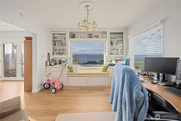 a living room with furniture a window and gym equipment