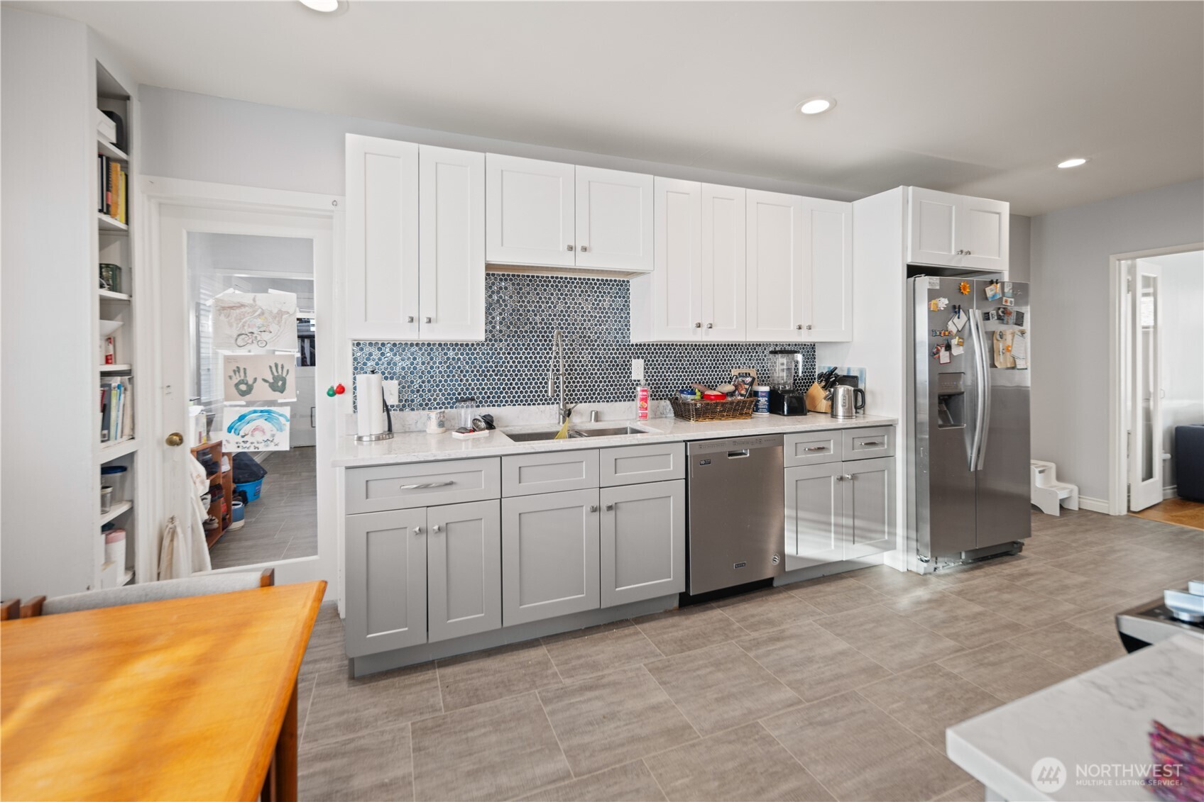 1788 Alki Avenue Southwest Seattle, WA 98116 - Photo 23 of 38 a kitchen with white cabinets and stainless steel appliances