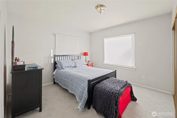 a bedroom with bed and a window