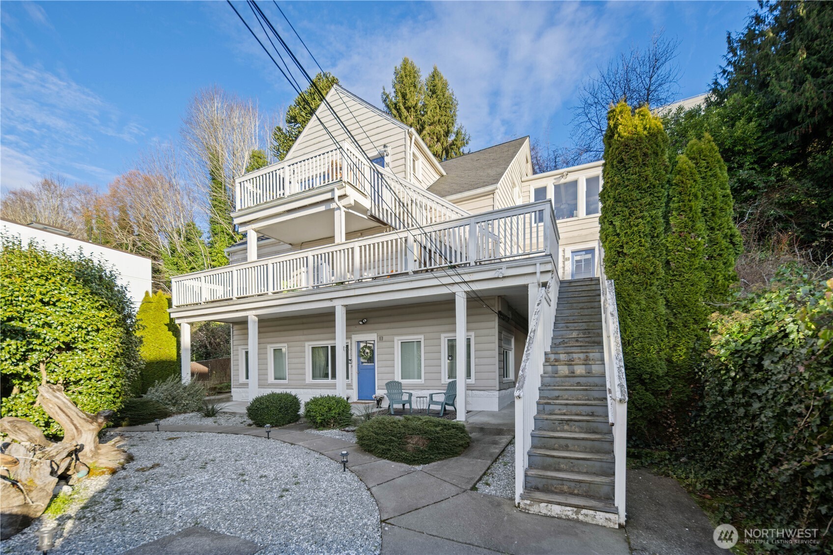 1788 Alki Avenue Southwest Seattle, WA 98116 - Photo 9 of 38 a view of a white house with large windows and a small yard