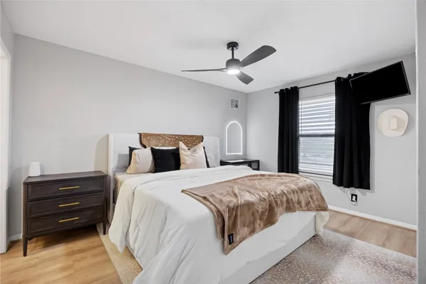 a bedroom with a bed and wooden floor