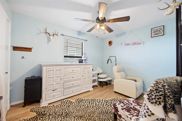 a bedroom with a baby bed and a window