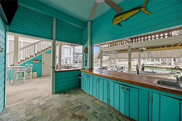a view of a balcony with chairs and wooden floor