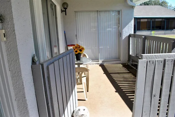 a view of a balcony with wooden floor and stairs