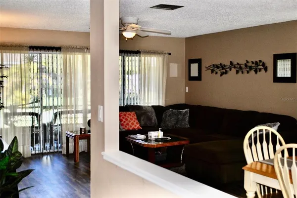 a dining room with furniture window and wooden floor