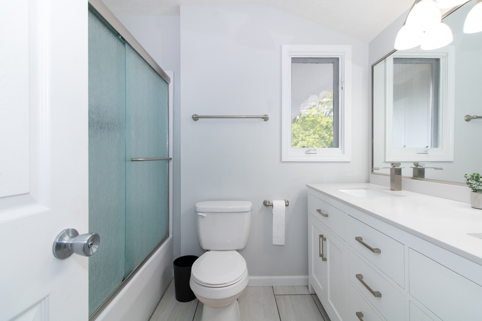 211 Sandra Lane Normal, IL 61761 - Photo 15 of 44 a bathroom with a granite countertop toilet a sink a mirror and a window