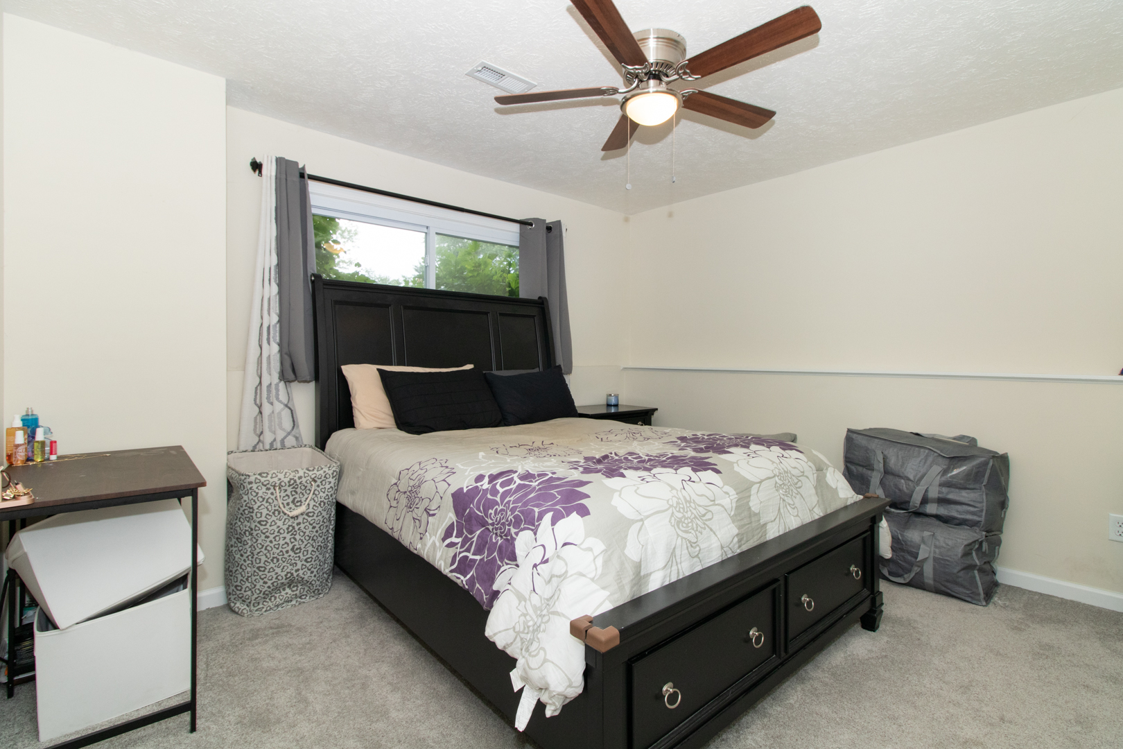 211 Sandra Lane Normal, IL 61761 - Photo 26 of 44 a bedroom with a bed and a chandelier