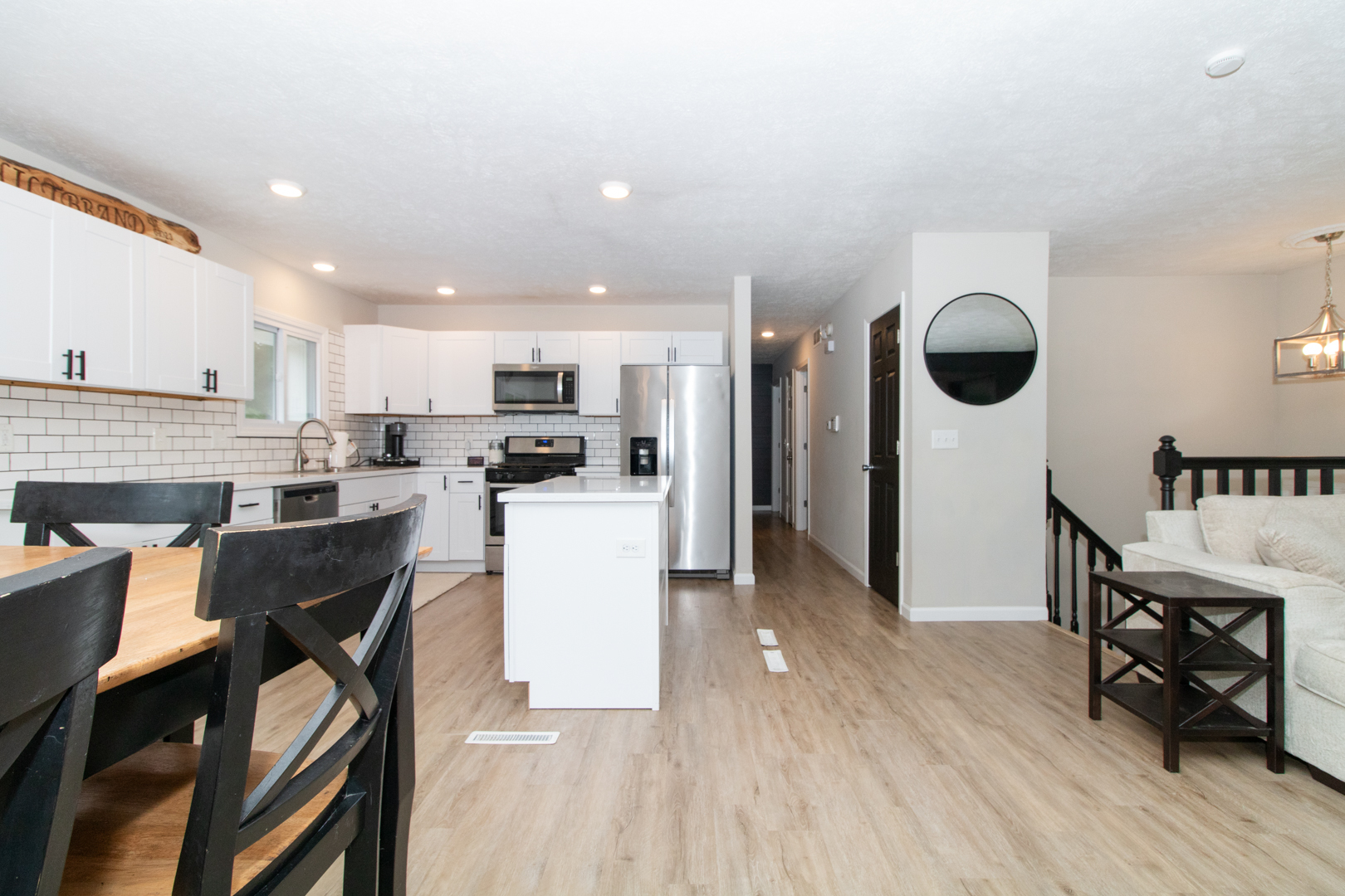 211 Sandra Lane Normal, IL 61761 - Photo 3 of 44 a kitchen with a table chairs and a refrigerator