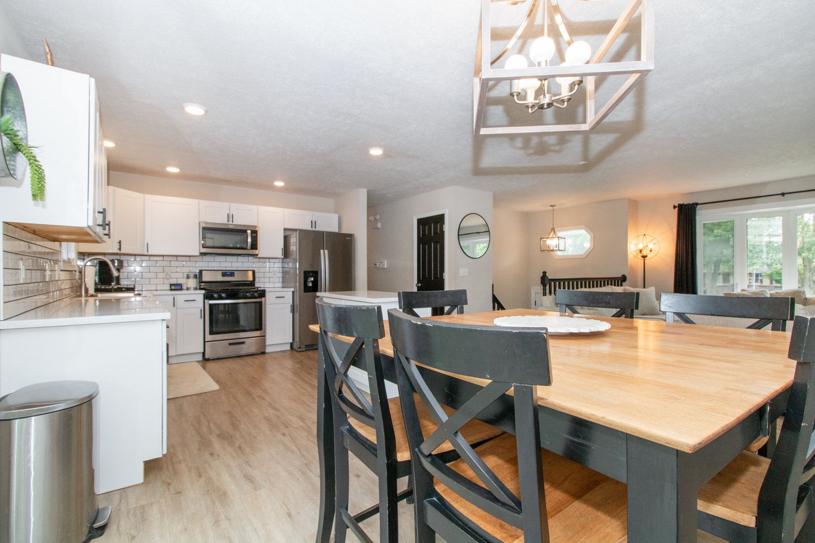 211 Sandra Lane Normal, IL 61761 - Photo 4 of 44 a kitchen with stainless steel appliances kitchen island granite countertop a table chairs and a refrigerator