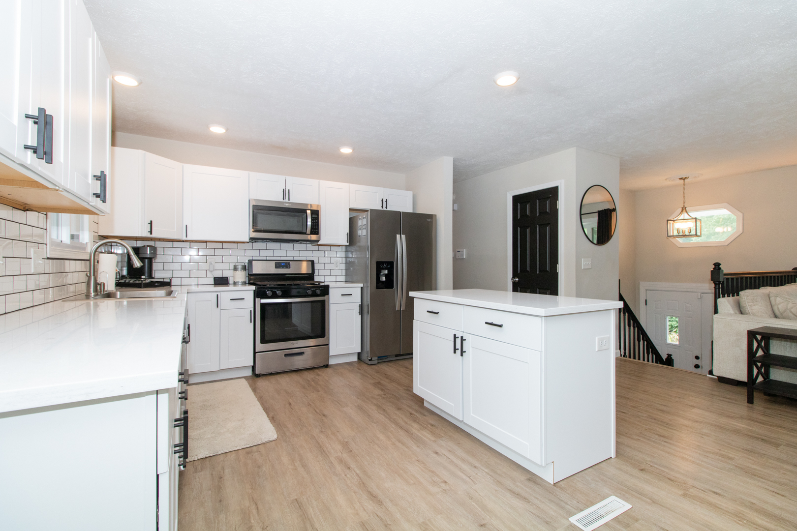 211 Sandra Lane Normal, IL 61761 - Photo 5 of 44 a kitchen with white cabinets and stainless steel appliances