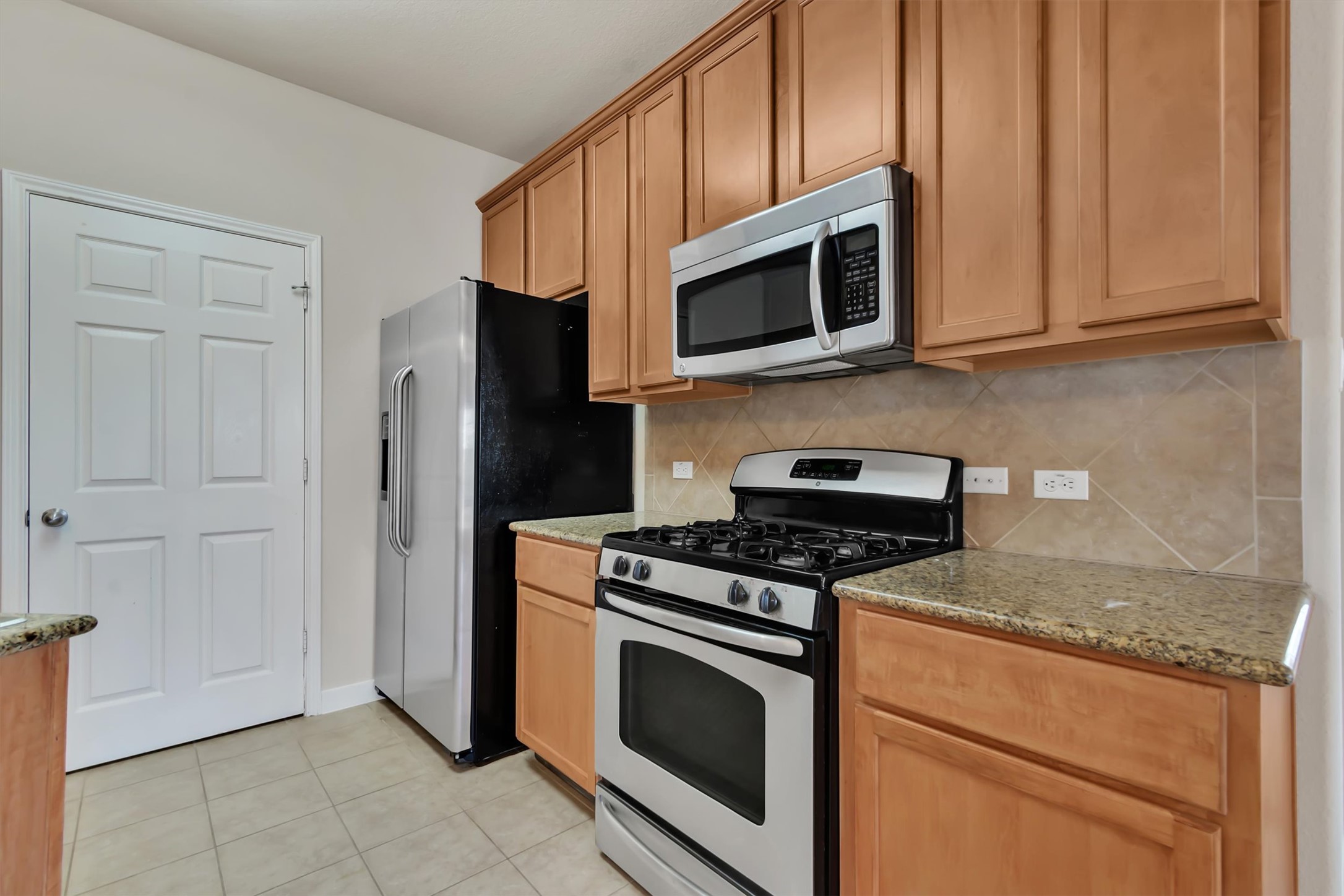 14815 Avery Ranch Boulevard, Unit 2A Austin, TX 78717 - Photo 5 of 27 Gleaming stainless steel appliances and abundant cabinet storage define this well-appointed kitchen.