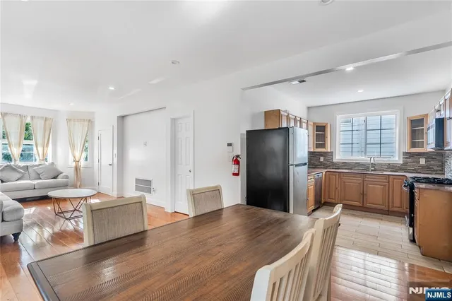 a kitchen with stainless steel appliances granite countertop a refrigerator and a stove top oven