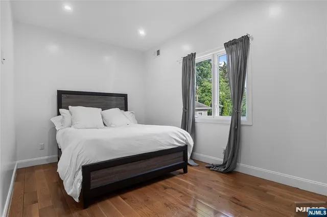 a bed sitting in a bedroom next to a window