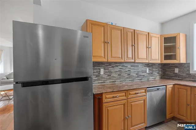 a kitchen with stainless steel appliances granite countertop white refrigerator a sink and a granite counter tops