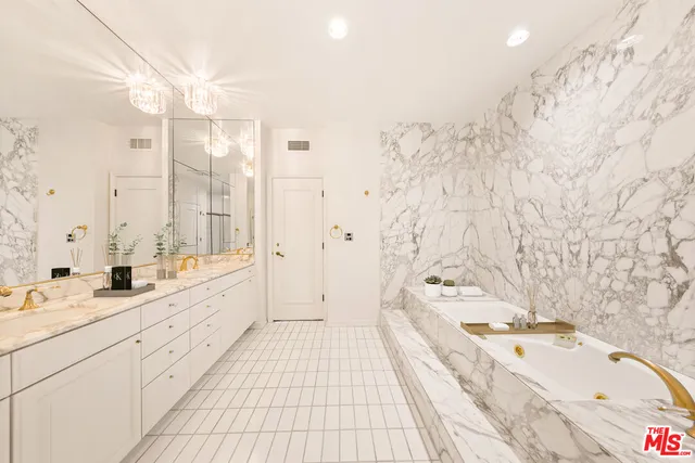 a spacious bathroom with double vanity sink a bathtub and shower