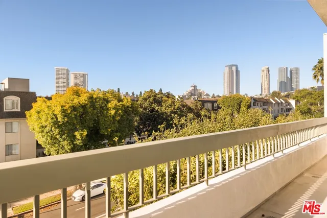 a view of a balcony with an outdoor seating