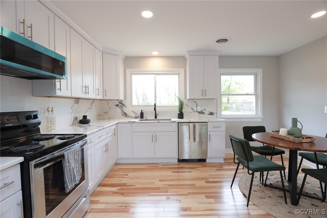 6626 Willson Road Henrico, VA 23231 - Photo 13 of 43 a kitchen with a stove a sink and a microwave