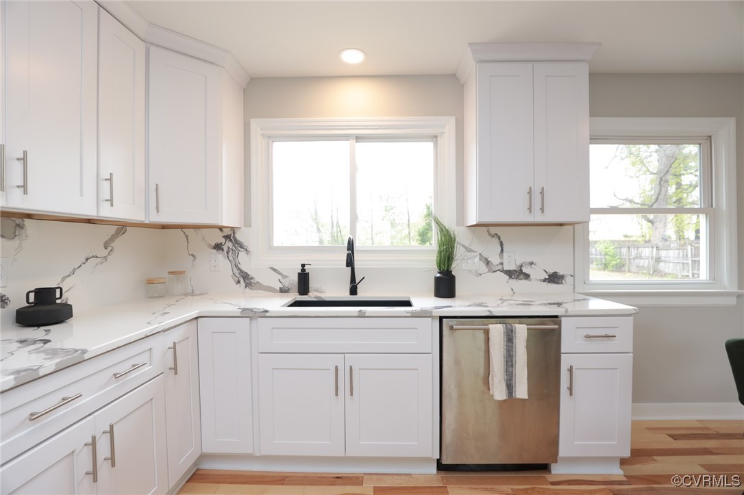 6626 Willson Road Henrico, VA 23231 - Photo 15 of 43 a kitchen with white cabinets appliances a sink and a window