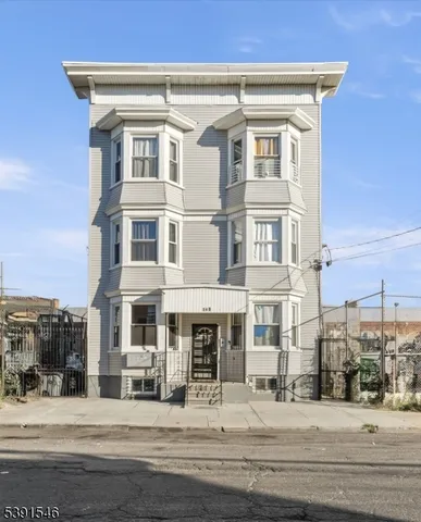 a front view of a building with parking space