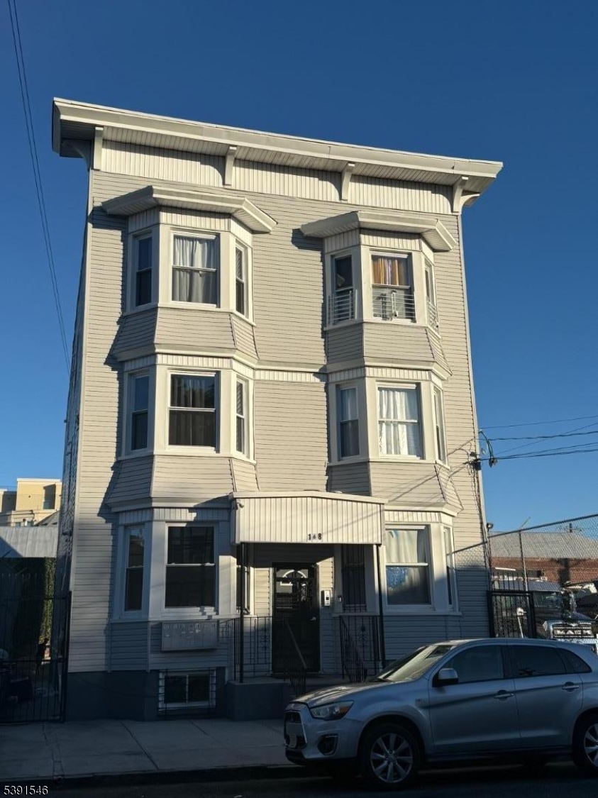 168 Sherman Avenue Newark, NJ 07114 - Photo 29 of 29 a front view of a building with parking space