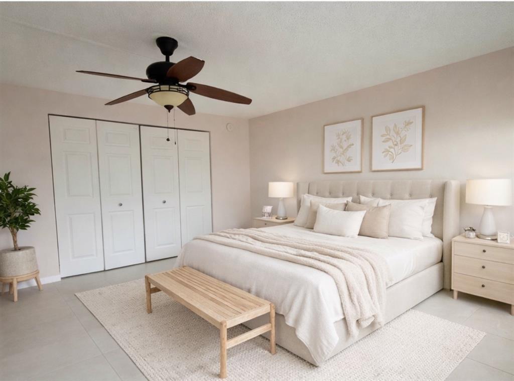 a spacious bedroom with a bed and a chandelier