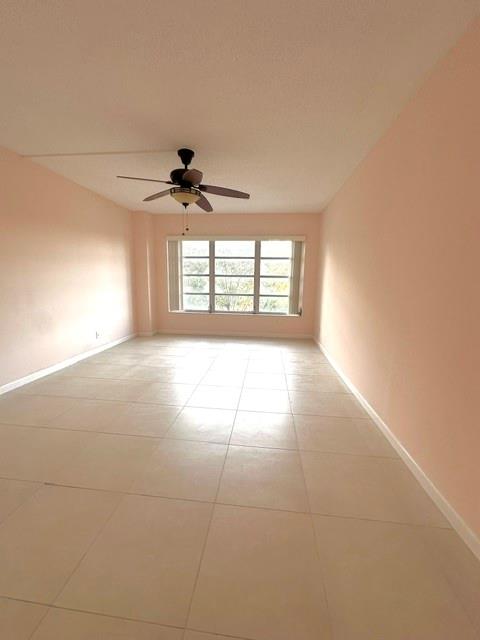 10777 West Sample Road, Unit 418 Coral Springs, FL 33065 - Photo 12 of 21 a view of a room with windows and a chandelier