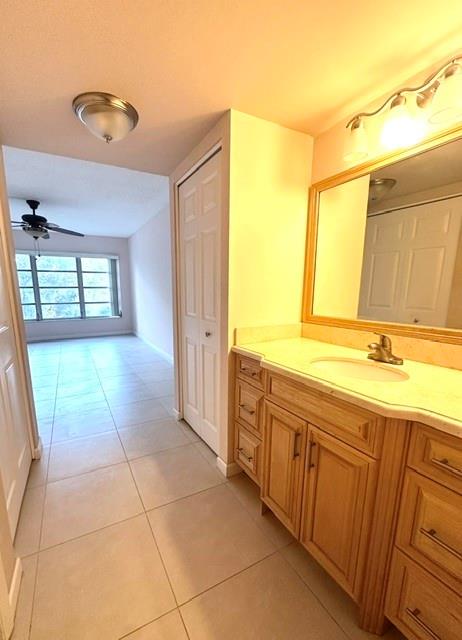10777 West Sample Road, Unit 418 Coral Springs, FL 33065 - Photo 14 of 21 a spacious bathroom with a granite countertop sink and a mirror